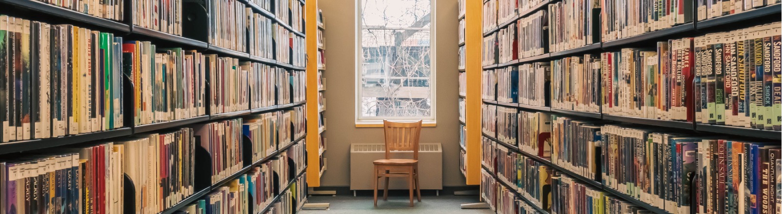 Library stacks with a window in the background